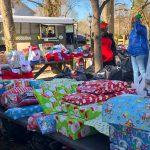 Christmas presents for needy community children wait by the Helping The Homeless Ministries food bus.